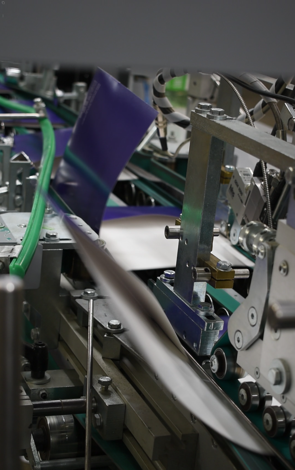 Close-up of folding and gluing machinery