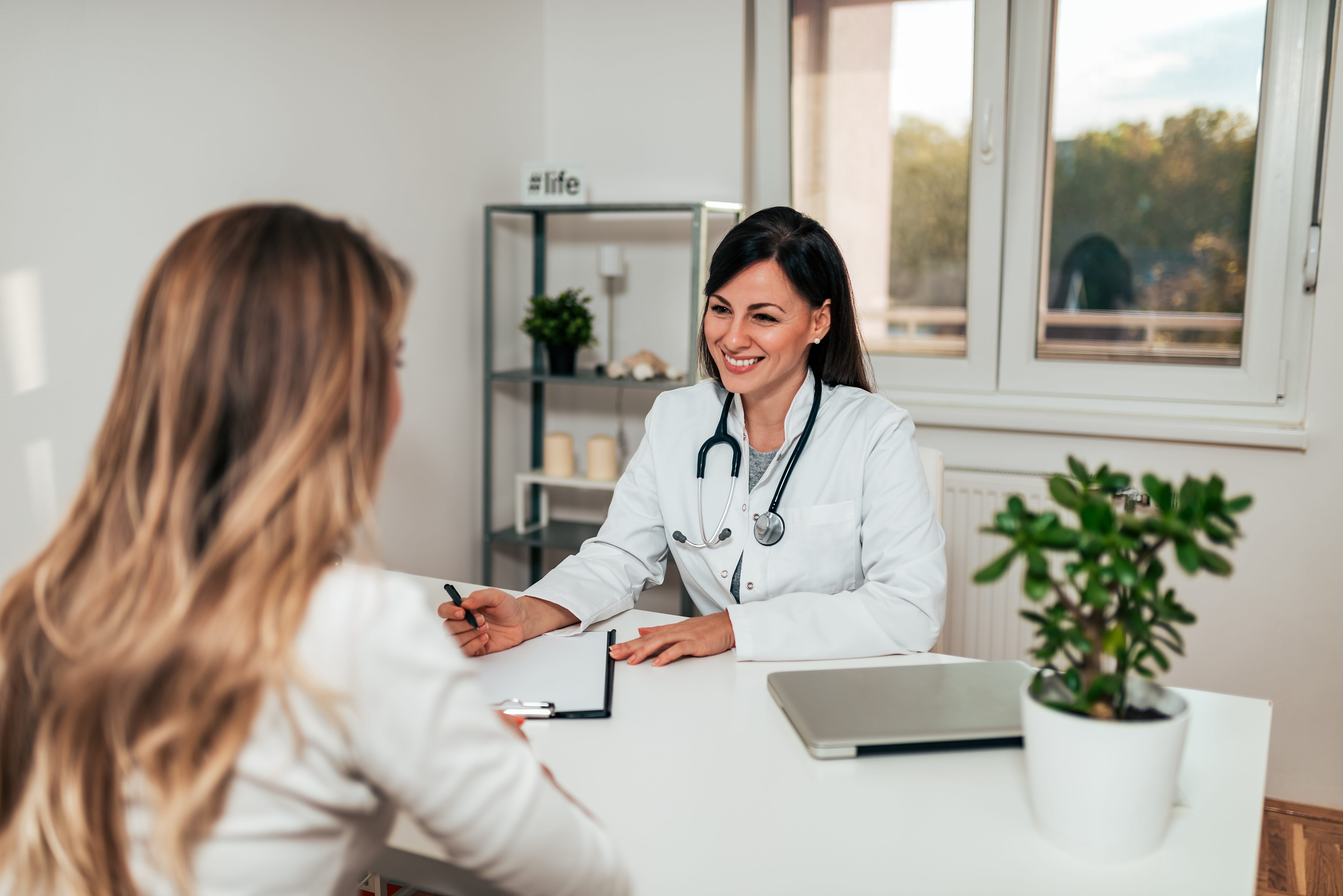 Smiling healthcare worker with a patient